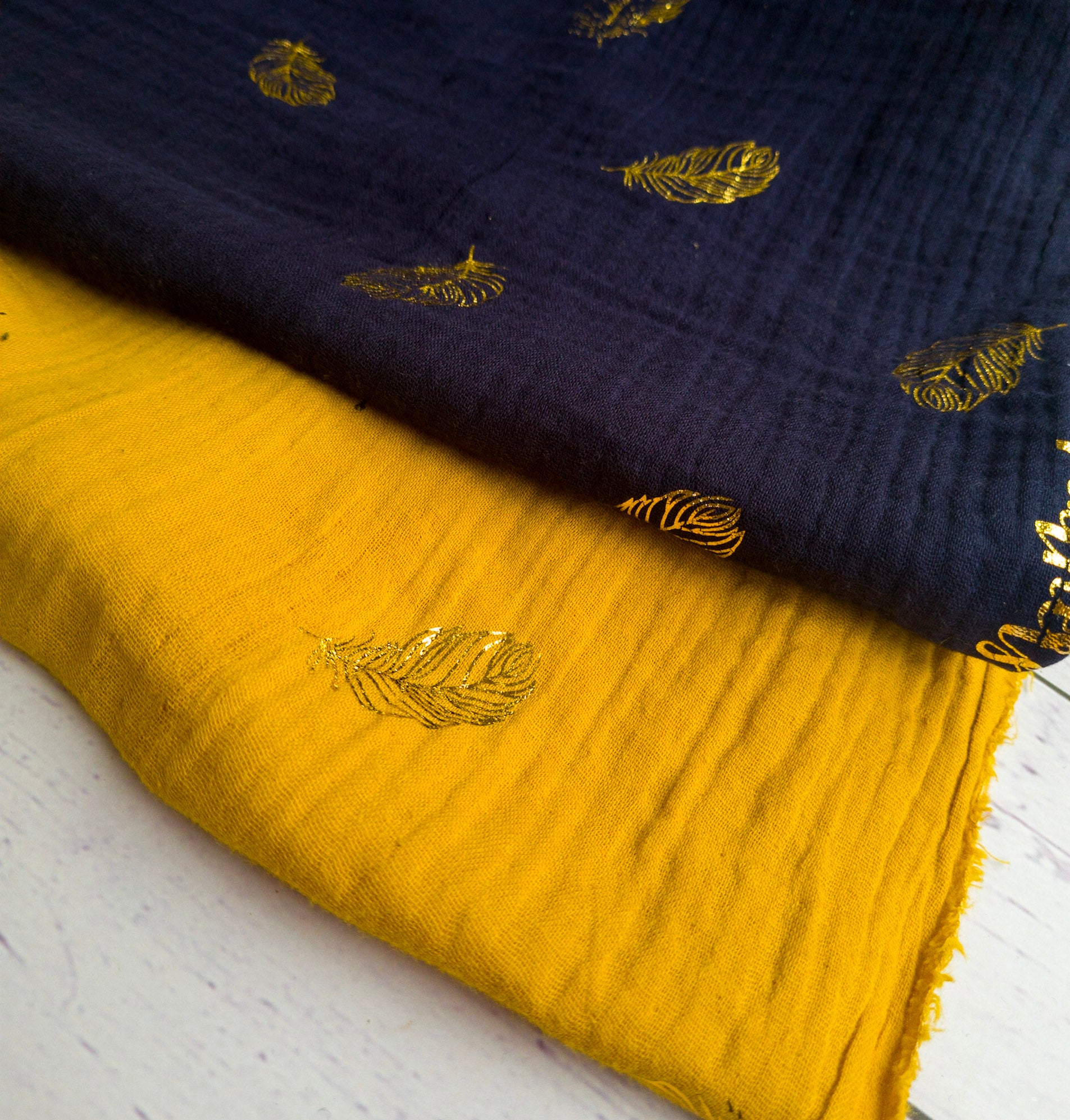 Metallic gold Feathers by Poppy double gauze dress fabric by the half