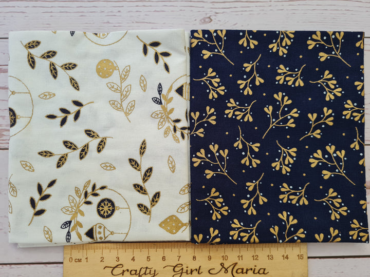 Two fabric swatches with gold and navy festive patterns on a white and navy background.