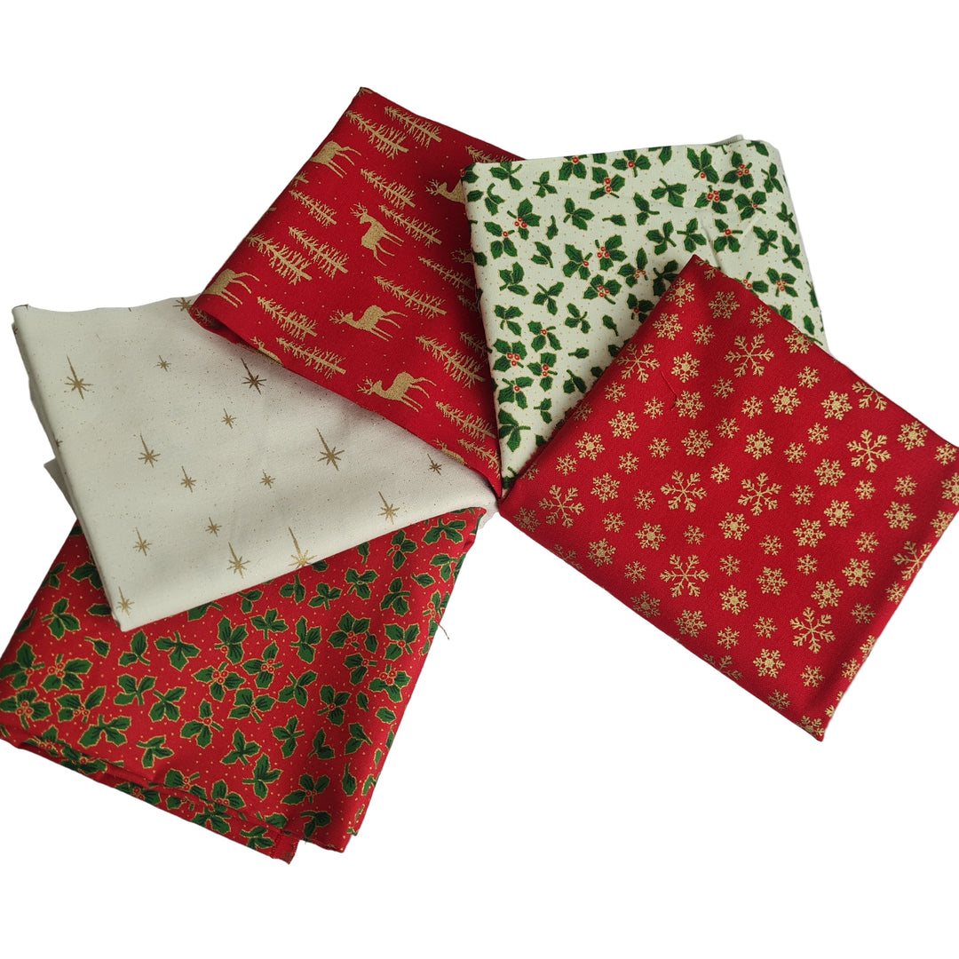 Five fat quarters of Christmas-themed fabric in red, green, metallic gold and cream