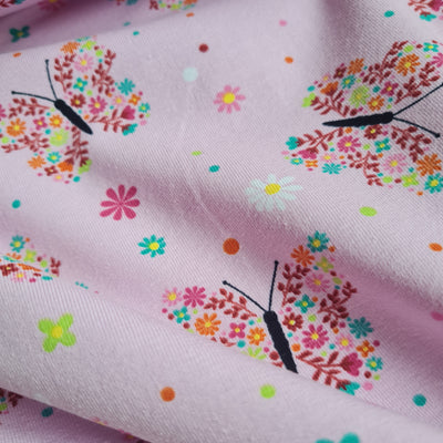 Tricot floral butterfly stretch cotton jersey knit fabric, by the half metre. Pink.